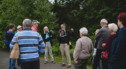 People gong on a guided walk in Heaton Park