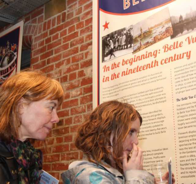Two women looking at Bellle Vue Exhibition Panel about the history