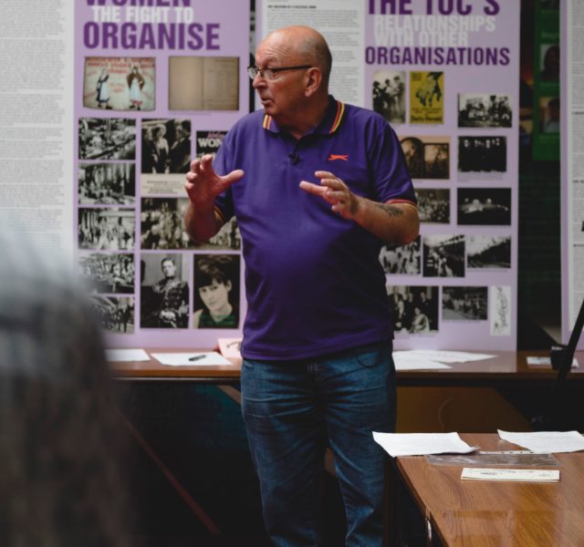 Man from TUC explaining a TUC exhibition