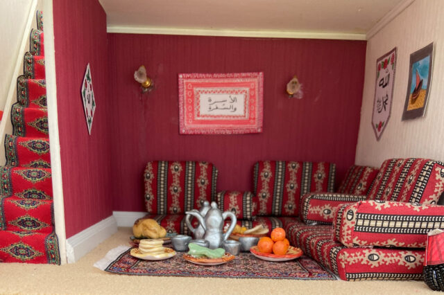 Close up of the Al-Usra Wal-Sufra doll's house exhibition featuring a traditional English layout turned into a British Arab one, complete with a majlis to host big meals for the entire family