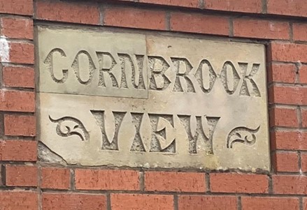 A sign set into red brickwork with the inscription 'Cornbrook View'