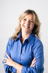Head shot of Jessica Bowles. Woman with blonde hair and blue shirt