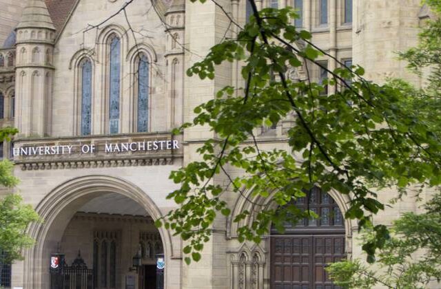 Image of a gothic building with the University of Manchester sign