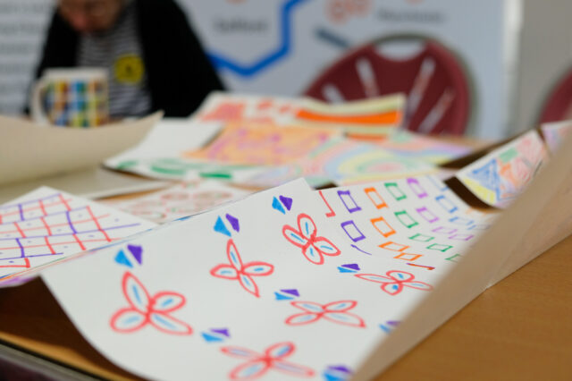 Images of different colourful patterns on a table.