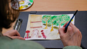 A person drawing some surroundings outside Manchester Central Library