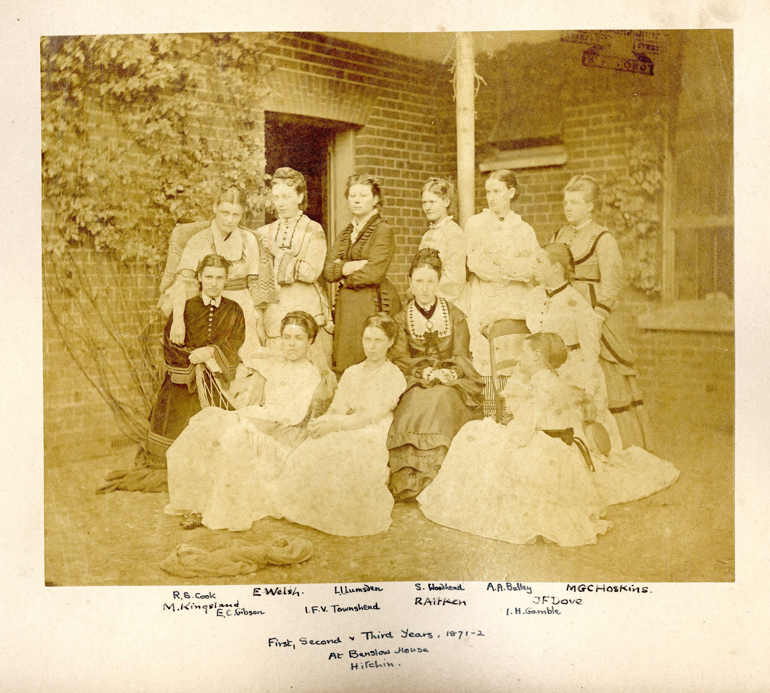 Sepia group photograph of twelve women students posed outside Benslow House in Hitchin in 1871–72, including Rachel Cook, later Rachel Scott.